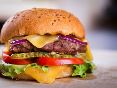 Big juicy cheeseburger with lettuce pickles and tomatoes